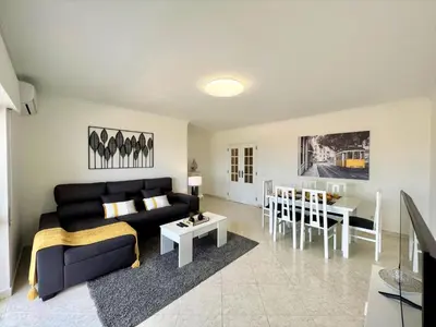 a living room with a couch and a table at Quarteira Panoramic View by Homing in Quarteira