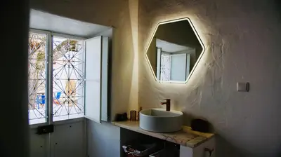 a bathroom with a sink and a mirror at Casa Pedra São Romão in São Brás de Alportel