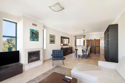 a living room with a couch and a fireplace at Casa dos Salgados in Albufeira