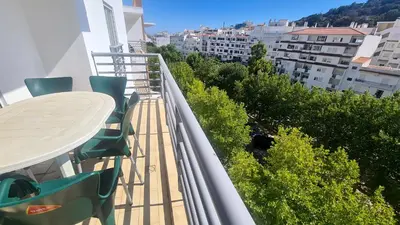 a balcony with a table and chairs on a building at Casa Old Town Splendida in Albufeira