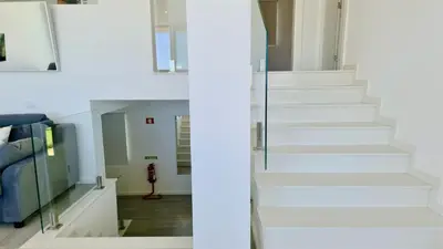 a staircase in a house with white walls and white floors at Marina Algarve-CleverDetails, located on the marina close to all main amenities in Vilamoura