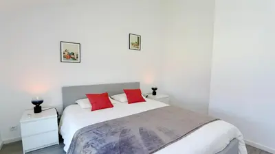 a bedroom with a white bed with red pillows at Marina Algarve-CleverDetails, located on the marina close to all main amenities in Vilamoura