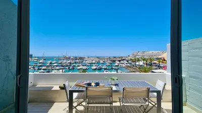 a balcony with a table and chairs and a view of a harbor at Marina Algarve-CleverDetails, located on the marina close to all main amenities in Vilamoura
