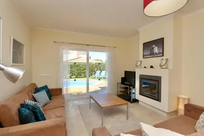 a living room with a couch and a fireplace at Villa Bolivia-CleverDetails in Vilamoura