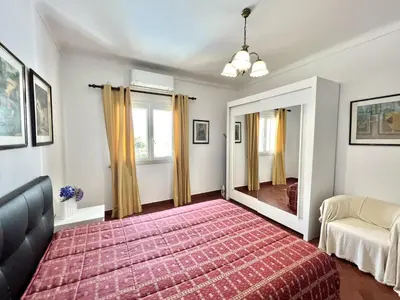 a bedroom with a large bed and a mirror at Vila Rose - Private Pool by HD PROPERTIES in Vilamoura