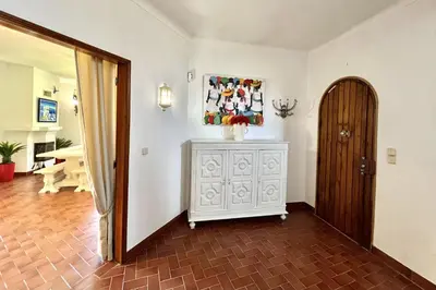 a room with a dresser with a picture on the wall at Vila Rose - Private Pool by HD PROPERTIES in Vilamoura
