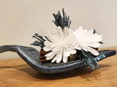 a vase with two white flowers in it on a table at Albufeira Sol Villas III by Stay ici Algarve Holiday Rental in Albufeira