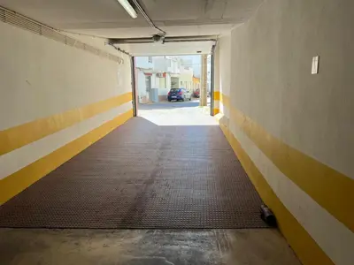 an empty hallway with a door to a parking garage at Mar e Sol by - T3 , wi-fi e estacionamento in Quarteira