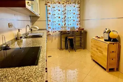 a bedroom with a large bed and a wooden floor at Mar e Sol by - T3 , wi-fi e estacionamento in Quarteira