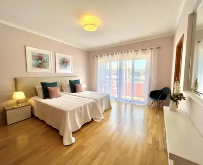 a bedroom with a large bed and a large window at Victoria I - Vasco da Gama by HD PROPERTIES in Vilamoura