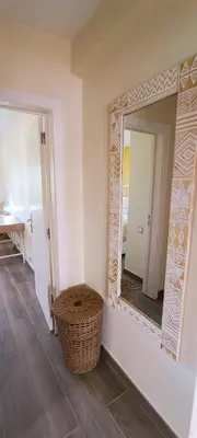 a mirror in a room with a wicker stool in front of it at Blue & Yellow Penthouse with Terrace at Balaia Mar in Albufeira