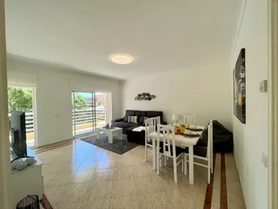 a living room with a table and a couch at Vilamoura Central 2 With Pool by Homing in Vilamoura