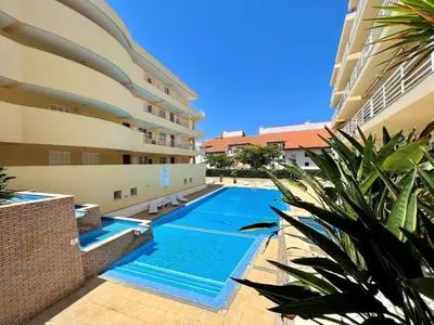 a swimming pool in front of a building at Vilamoura Central 2 With Pool by Homing in Vilamoura