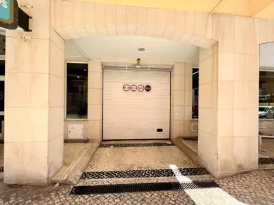 a large white building with a white garage door at Vilamoura Central 2 With Pool by Homing in Vilamoura