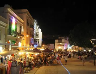 a crowd of people walking down a street at night at Beautiful 2-Bed Apartment in Olhos de Agua in Albufeira