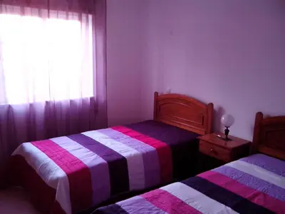 a bedroom with two beds and a window at Beautiful 2-Bed Apartment in Olhos de Agua in Albufeira