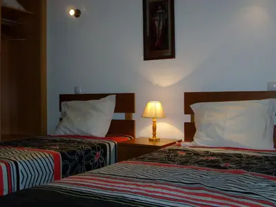 a hotel room with two beds and a lamp at Stunning 1-Bed Apartment in Olhos de Agua in Albufeira