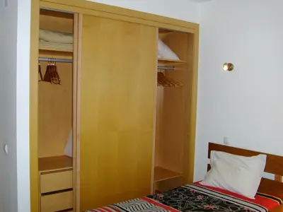 a wooden closet with a bed in a room at Stunning 1-Bed Apartment in Olhos de Agua in Albufeira