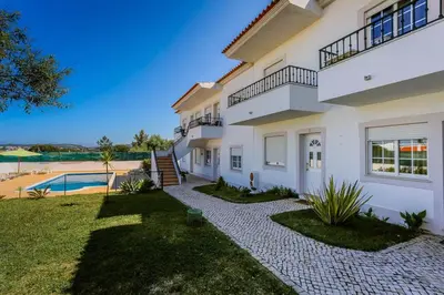 a large white house with a yard and a swimming pool at 1 Bed Flat - Sleeps 2 - Parking - Wifi in Albufeira
