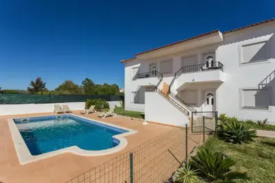 a villa with a swimming pool in front of a house at 1 Bed Flat - Sleeps 2 - Parking - Wifi in Albufeira