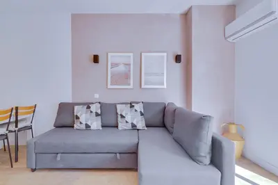 a living room with a gray couch and a table at AL - Apartamento Pontemira in Quarteira