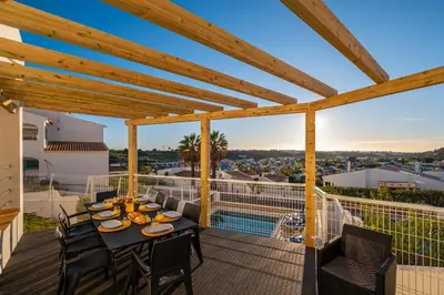a patio with a table and chairs on a balcony at Villa Kevin by Atlantic Places in Albufeira
