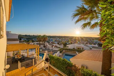 a view from the balcony of a house with the sunset at Villa Kevin by Atlantic Places in Albufeira