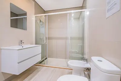 a bathroom with a shower and a toilet and a sink at Villa Kevin by Atlantic Places in Albufeira