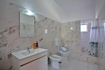 a white bathroom with a sink and a toilet at Villa Terra by Villa Plus in Albufeira