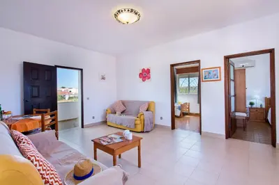 a living room with a couch and a table at Villa Terra by Villa Plus in Albufeira