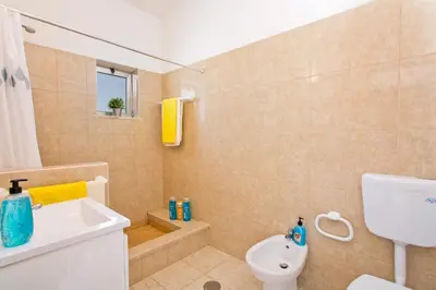 a bathroom with a sink and a toilet and a shower at Villa Terra by Villa Plus in Albufeira