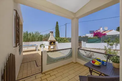 a balcony with a table and a grill on it at Villa Campos by Villa Plus in Guia