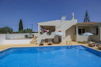 a swimming pool in front of a house at Villa Campos by Villa Plus in Guia