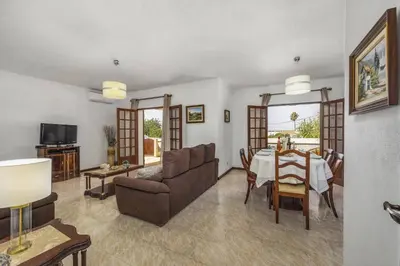 a living room with a table and a couch at Villa Campos by Villa Plus in Guia