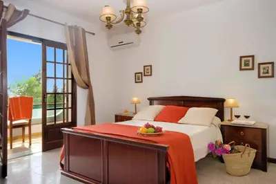 a bedroom with a bed with a plate of fruit on it at Villa Campos by Villa Plus in Guia