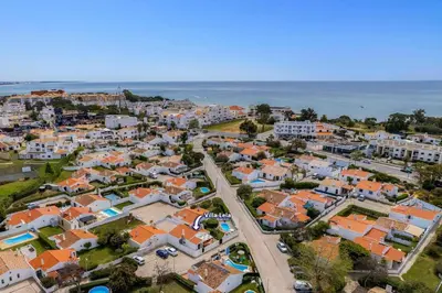 an aerial view of a city with houses and the ocean at Villa Lela by Villa Plus in Albufeira