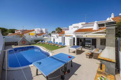 an aerial view of a town with houses and the ocean at Villa Pina by Villa Plus in Albufeira