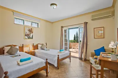 a bedroom with two beds and a balcony at Villa Boavista by Villa Plus in Boliqueime