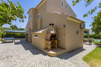 a building with a pizza oven in a courtyard at Villa Boavista by Villa Plus in Boliqueime
