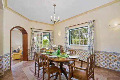 a dining room with a table and chairs at Villa Boavista by Villa Plus in Boliqueime