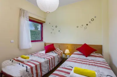 a bedroom with two beds and a window at Villa Marina View by Villa Plus in Albufeira
