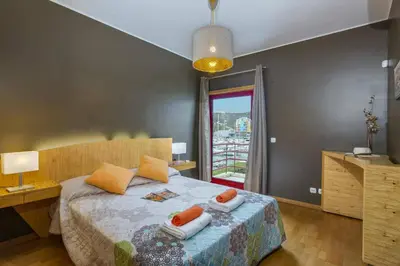 a bedroom with a bed with two pillows on it at Villa Marina View by Villa Plus in Albufeira