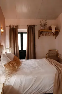 a bedroom with a large white bed with a window at Casa Rústica em Alte - KARMEA HOUSES in Alte