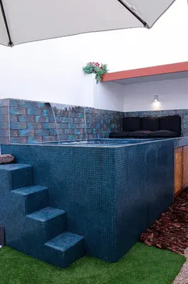 a bar with blue tiles on the wall and stairs at Casa Rústica em Alte - KARMEA HOUSES in Alte
