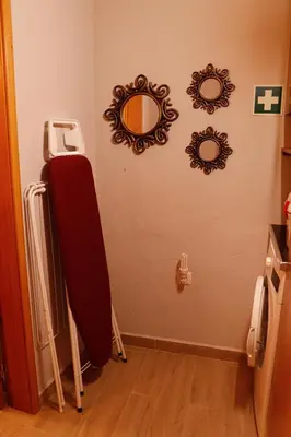 a room with two mirrors on the wall and a suitcase at Casa Rústica em Alte - KARMEA HOUSES in Alte