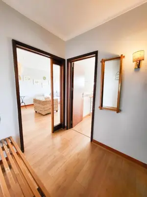 a living room with two mirrors on the wall at T1 Tenis Golf Mar- Marina de Vilamoura- Piscina in Vilamoura