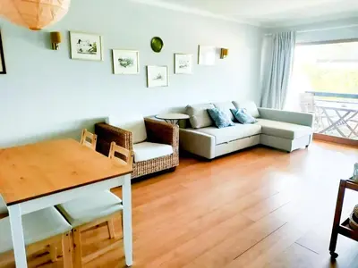 a living room with a couch and a table at T1 Tenis Golf Mar- Marina de Vilamoura- Piscina in Vilamoura