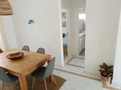 a dining room with a wooden table and chairs at Apartamento 90m2 com vista mar - Albufeira in Albufeira