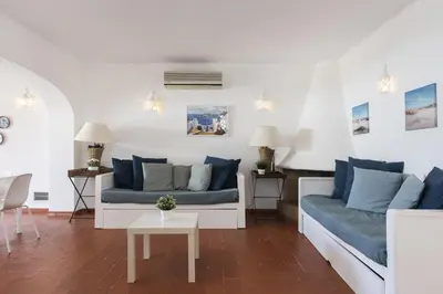 a living room with two couches and a table at Aldeia do Golfe - Private condominium by HD in Vilamoura
