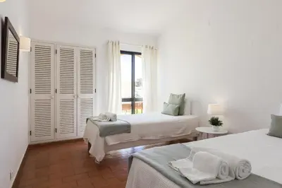 a white room with two beds and a window at Aldeia do Golfe - Private condominium by HD in Vilamoura